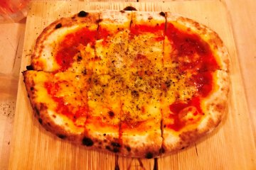 Tomato based pizza