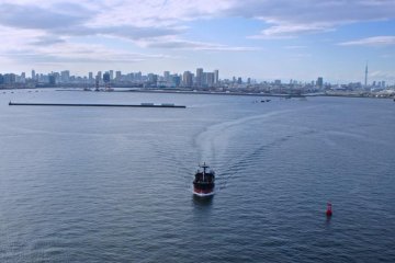 Trawlers pass below and Tokyo Skytree in the distance