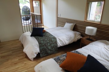 A bedroom at the Deluxe Cottage with a view of Mount Fuji