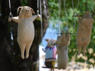 The animals from "Circus" by Tomio Okayama are suspended in trees at the park