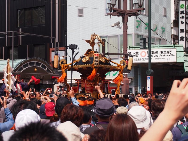 <p>The mikoshi being borne around the streets that have been temporarily blocked off for the day. The subways still work, though. Get off at Asakusa Station on the Ginza line and follow the crowd out. You can&#39;t miss it.</p>