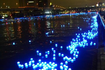 Thousands of LED lights passing along the river.