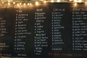 The large blackboard with an extensive menu is the only sign that lets passersby know that this is a cafe, not someone's old house.
