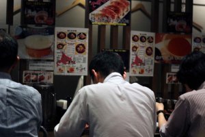 Diners slurping up their noodles at Kanisenmon Keisuke.