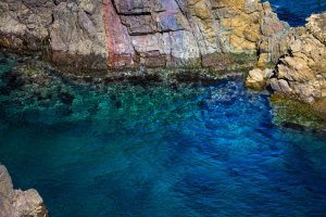Rainbow cliffs meet the clear blue Sea of Japan
