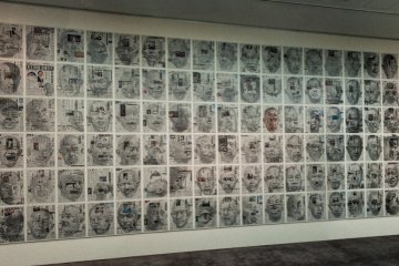<p>The room is filled with drawings of Yoshimura&#39;s face on newspapers.</p>