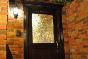 One of two crystal-paned doors in the waiting room of Swallowtail