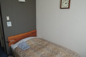 Single room hotel bed with a yukata