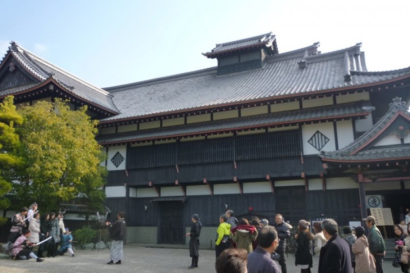 Cast pose for photos with visitors in front of the Ninja Theatre