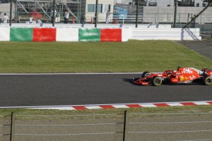 A Ferrari race car passing by to race for the winner of Japanese Grand Prix