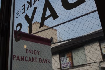 Keep your heads up to see the cafe's signature on its front windows at Pancake Days in Harajuku Bell Pier just moments from Omotesando and Meiji Jingumae.