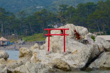 Red torii (Shinto gate) on the rocks