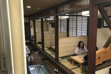 The first floor offers bar, table, and tatami booth seating