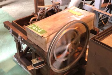 A smaller and older machine to roll the tea leaves
