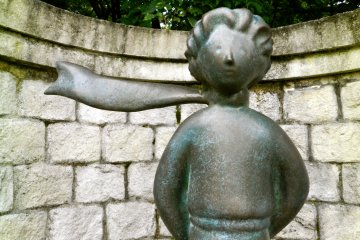 There are several statues of the Little Prince around the museum grounds, as well as various other characters