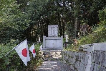 The flag of Nippon lined the path to this grave