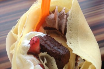 <p>Blue Seal&#39;s crepes are stuffed then rolled like an ice cream cone. This crepe contains vanilla ice cream, various whipped creams, strawberries, and chocolate cake</p>