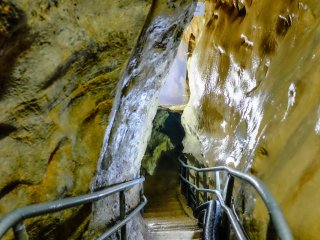 The cave features narrow walkways with low overhead clearance, giving it a nice and rustic feeling