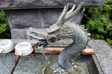 Metal dragon at an ablution well