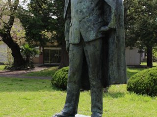 A courtyard statue representing a student from the Former Second High School. Note the western clothing paired with Japanese geta sandals.