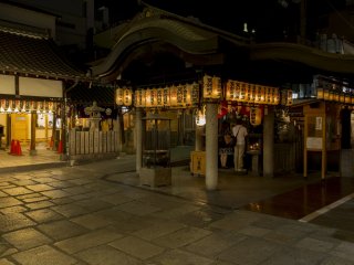 The lanterns of the shrine illuminate the cobblestones at night at Hozenji Yokocho between Nanba and Dotonbori