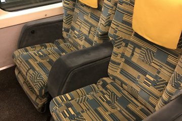 The seats in the green car are wider and longer