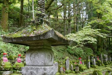 Multiple stone lanterns line the route 