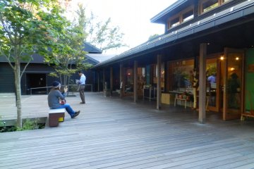 The wooden terrace is lined with shops.