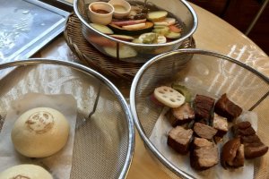 Steamed buns, veggies, and meat at Jigoku Mushi Kobo Kannawa