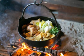 Food preparation in the villa’s irori (traditional Japanese sunken hearth)
