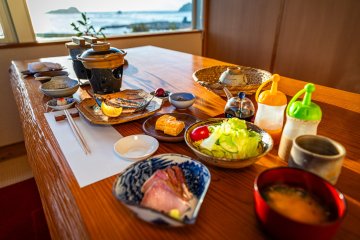 A multi-course Japanese breakfast at an inn looking over Kitaura Harbor