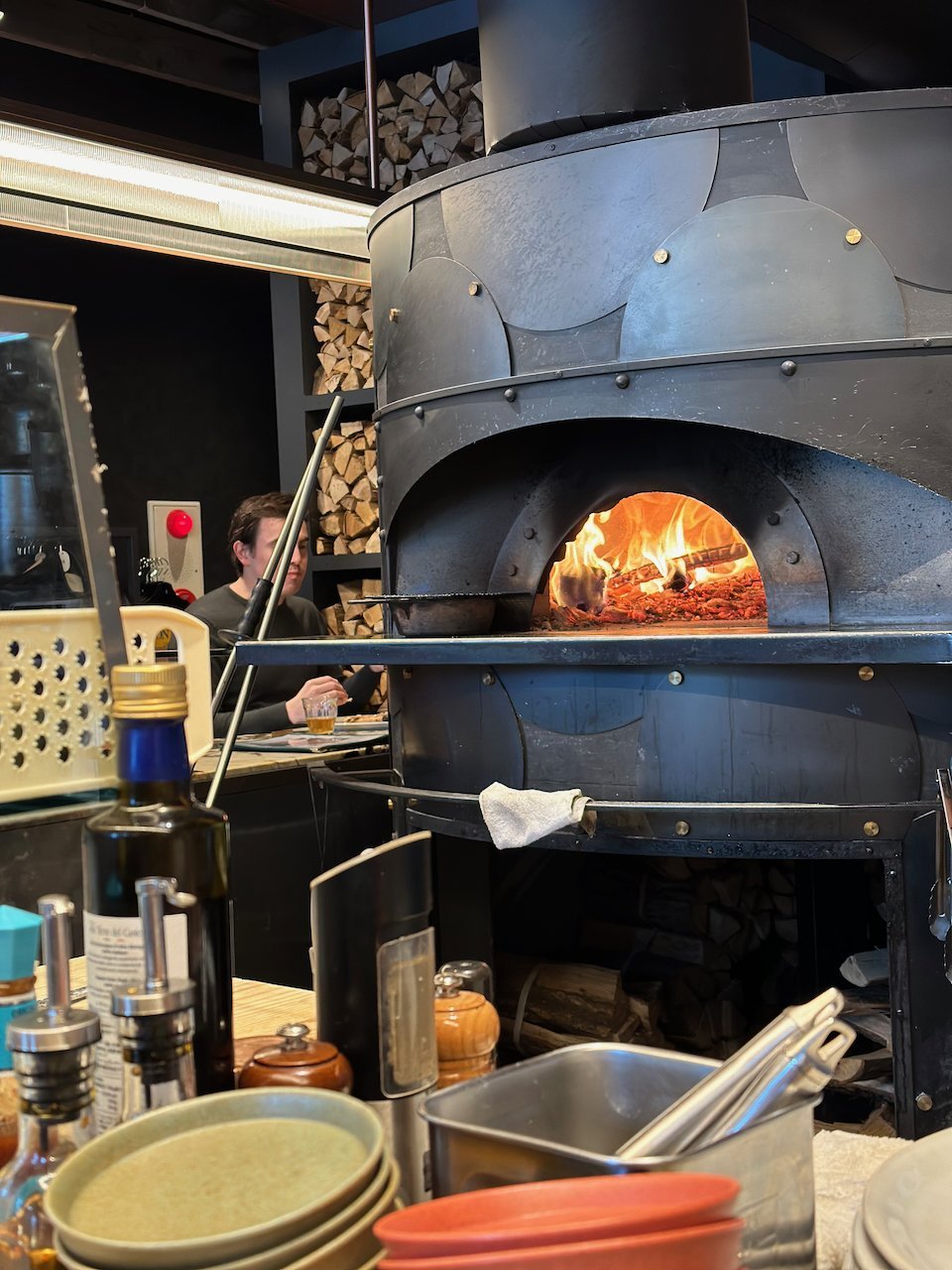 The wood-fired oven can be seen at the counter