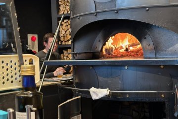 The wood-fired oven can be seen at the counter