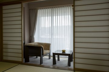 Each room has a small seating area at Hotel Ravie Kawaryo near Ito Station