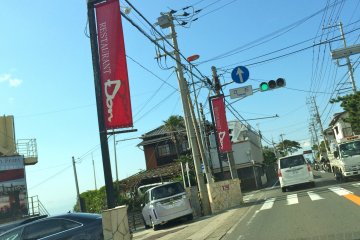 <p>On Route 134, Restaurant DON is flagged by these maroon banners</p>