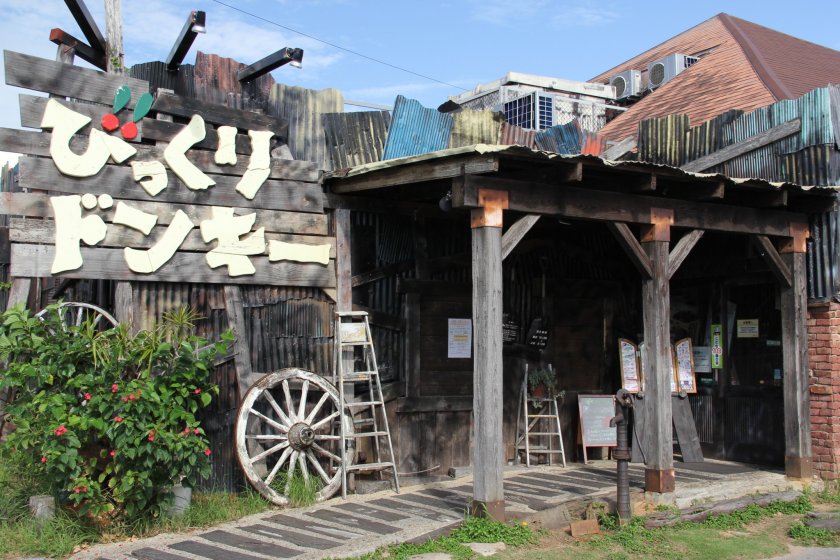 Bikkuri Donkey's Chatan location is decorated with faded wood and old aluminum siding