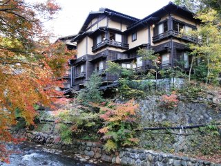 A ryokan against a backdrop of changing maples