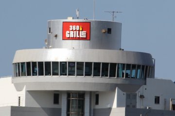 <p>360 Grille sits atop the building on the busy intersection of Routes 130 and 58 in Chatan</p>