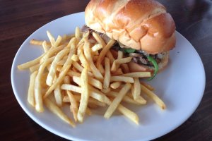 The Philly cheesesteak sandwhich comes with shoestring french fries