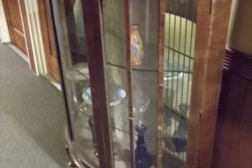 <p>A cabinet of antique glassware in the corridor</p>