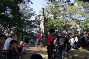 A busy day at Mt. Hiwada&#39;s summit, which is filled with people eating lunch during the height of fall-colors season.