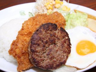 A set meal with pork cutlet, egg, hamburger steak, salad, and rice
