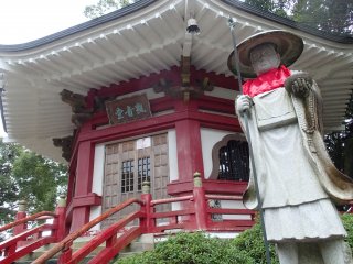 Statue of Kobo Daishi in front of a pagoda