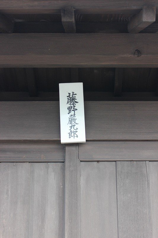 A period nameplate hangs on the outside gate