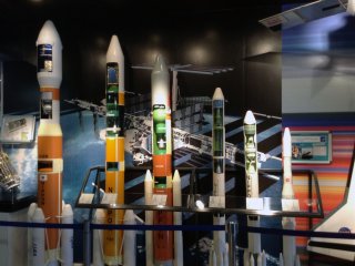 Various rocket designs line the wall.&nbsp;