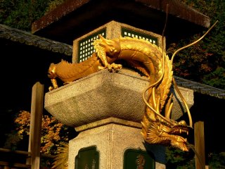 An impressive golden dragon coils around a large stone lantern. Water spouts from his mouth into a basin below. I was told that if you wash money in the water, it will increase