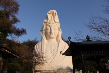 <p>This statue, a bust figure which is pure white and sits high up on a hill overlooking Ofuna Station, can be seen from miles.</p>