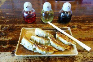 Gyoza perfection: golden and crispy with a juicy filling. The dipping sauce is made from the liquid in the three bottles - soy sauce, vinegar and chili oil.